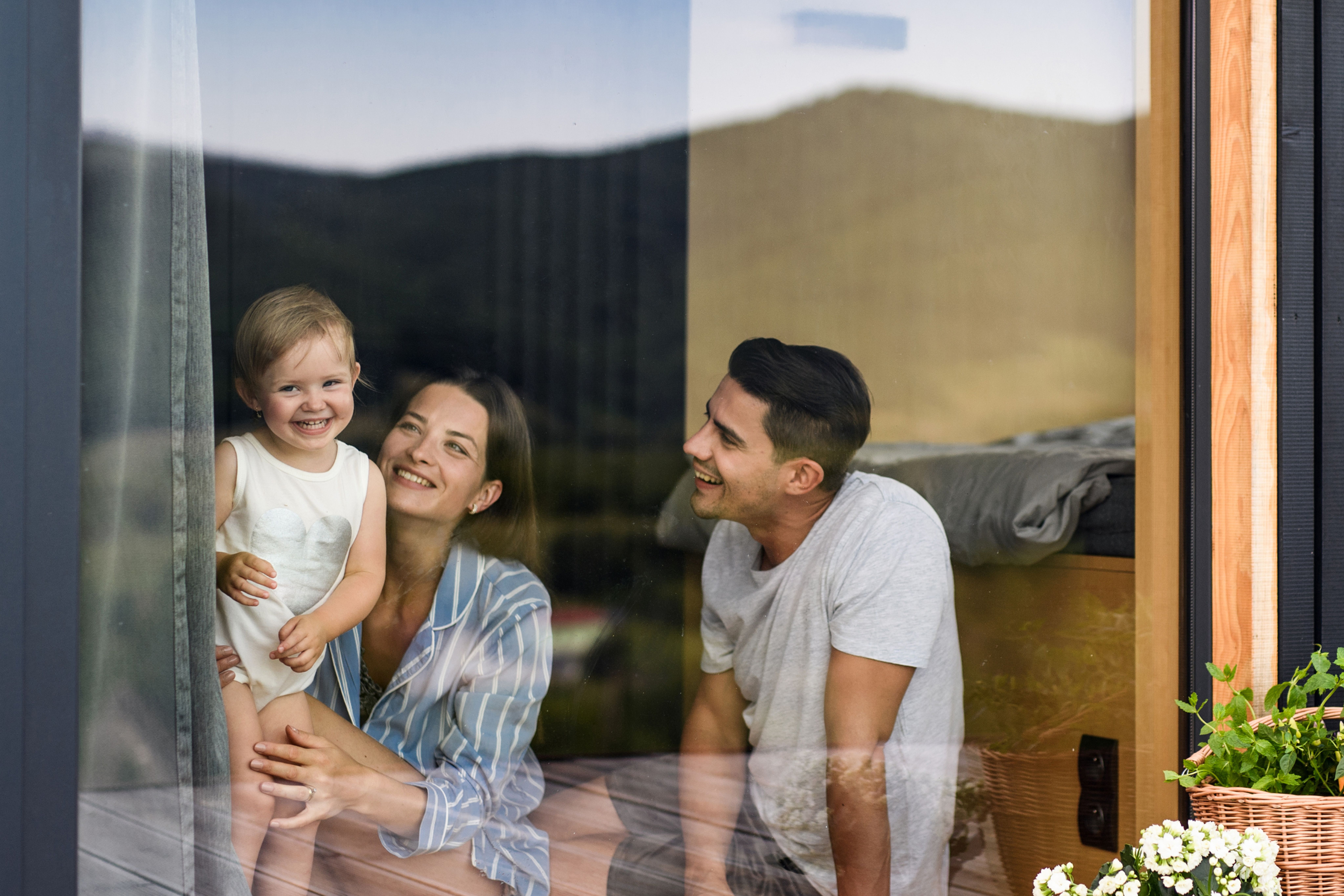 Parents and child through the window of an investment property